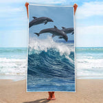 Dolphins Jumping Over Waves Print Beach Towel