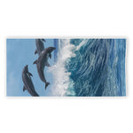 Dolphins Jumping Over Waves Print Beach Towel