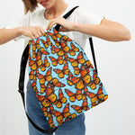 Orange Monarch Butterflies Pattern Print Drawstring Backpack