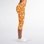 Orange Paw And Bone Pattern Print Women's Capri Leggings
